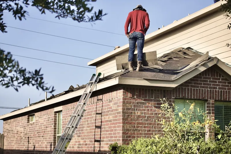 Professional roofer working on a residential roof in North Chatham